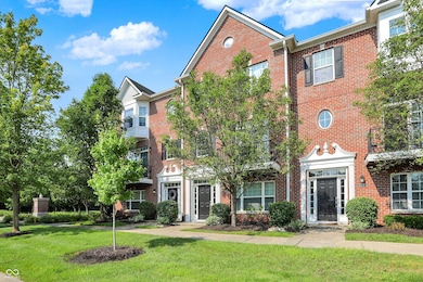 traditional-style house with brick siding and a front lawn