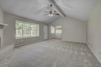 Spacious living room with fresh carpet, vaulted ce