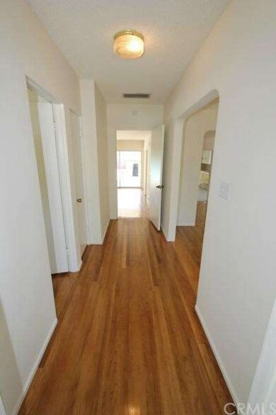 Entry hallway with Living room on the left and bed
