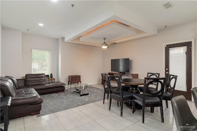 Living room with ceiling fan, light tile patterned flooring, and recessed lighting