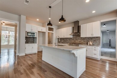 upped white kitchen with stone countertops
