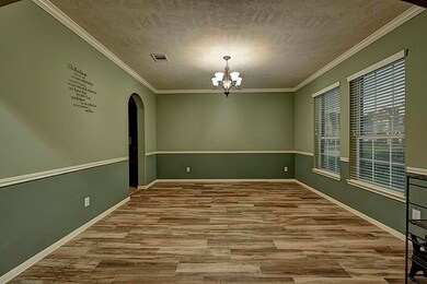 Large dining room with wood plank style tile flooring.  Located at the front of the house off the foyer with easy access to the kitchen.