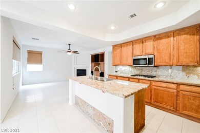 KITCHEN OVERLOOKS FAMILY ROOM WITH FIREPLACE