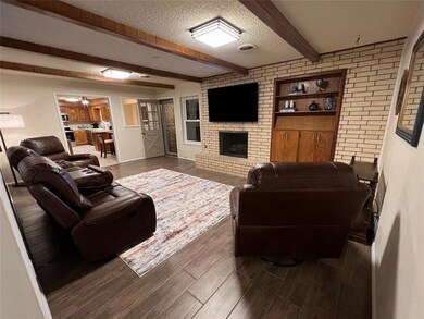 Living room with a fireplace, hardwood / wood-styl