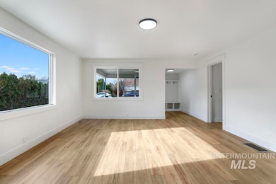 Unfurnished room with light wood-style floors and baseboards