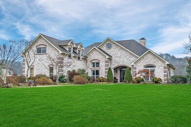 This gorgeous luxury home has tons of curb appeal with its whitewashed brick exterior and landscaping.