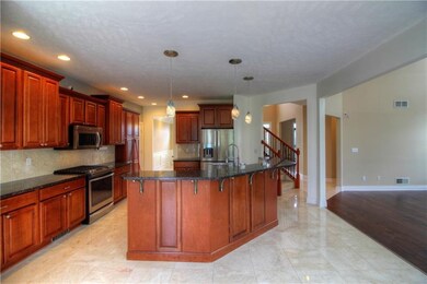Marble flooring, tiered lighting, eating counter o
