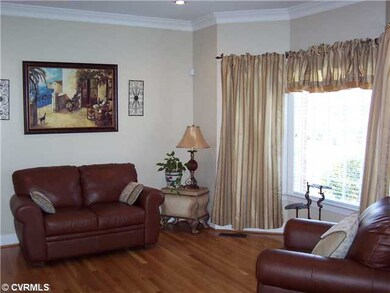 Living Room - Formal living room with bay window, hardwood floors and french doors leading to family room
