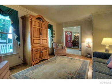Formal living room with hardwood floors and crown 