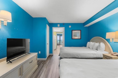 Bedroom with wood finished floors and baseboards