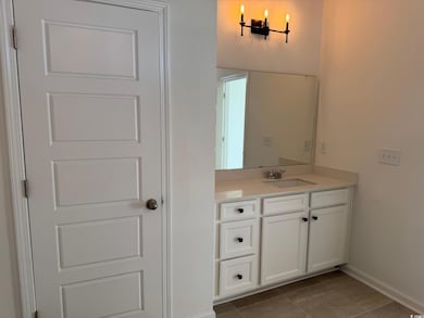 Bathroom featuring tile patterned flooring and van