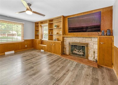 Office/den with fireplace, built-in shelves and ce