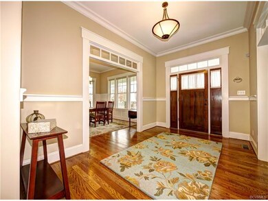Charming entryway with decorative trim and transom