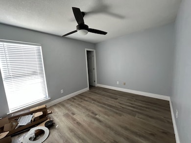 Empty room with baseboards, a textured ceiling, c