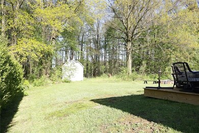 Extra wooded lot with Mini-Barn. Fire pit and back deck.