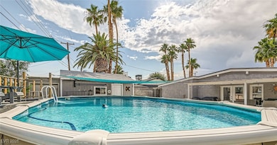 View of pool featuring an outdoor structure, frenc