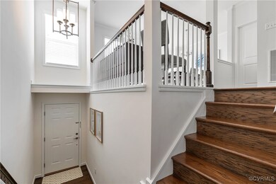 Staircase with a notable chandelier