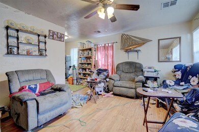 Living room with hardwood / wood-style flooring an