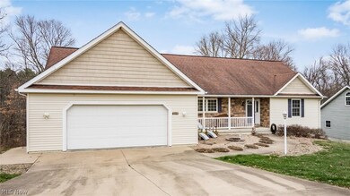 Single story home with a porch and a garage
