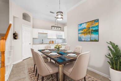 This virutally staged dining area is open to the l