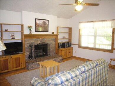 Living room with hardwood floors and built ins