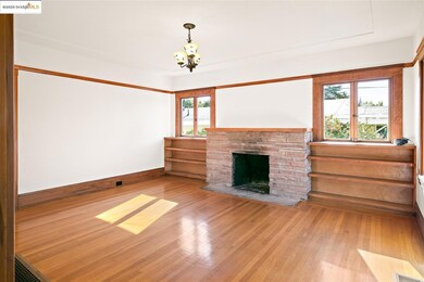 Unfurnished living room with wood-type flooring and a fireplace with flush hearth