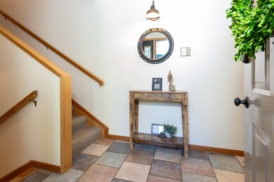 Foyer entrance with stairs and baseboards