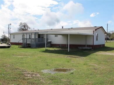 Back View (after heavy rain) with 2 carport and co