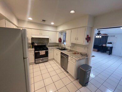 Kitchen w/ all stainless steel appliances except fridge