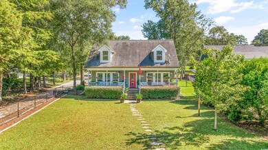 Cape cod-style house with a front lawn and covered