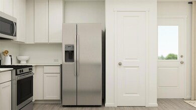 Kitchen with stainless steel appliances, white cab