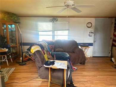 Living area with ceiling fan, light wood finished