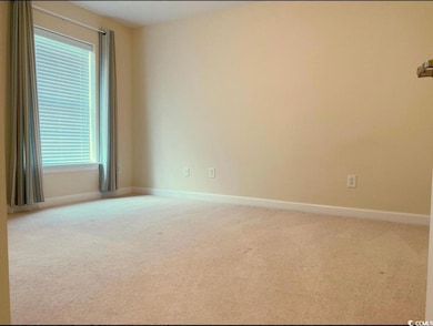 Unfurnished room with baseboards and carpet floors