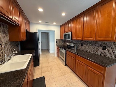Kitchen featuring a sink, tasteful backsplash, st