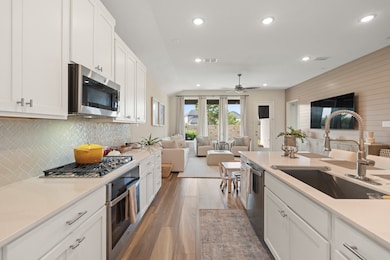 The cook's kitchen has a walk-in pantry, quartz countertops and luxury vinyl flooring.