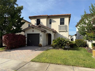 Mediterranean / spanish home with decorative driveway, a garage, a front lawn, stucco siding, and a tile roof