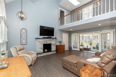 Family Room with Interior Balcony and Stone Firepl