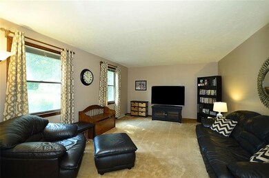 Generous-sized Living Room has neutral tone carpet