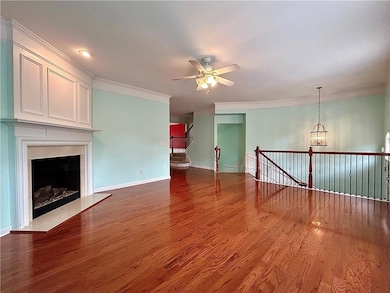 Unfurnished living room featuring ornamental moldi