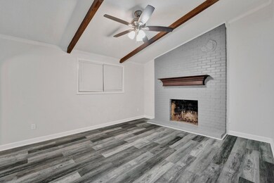 Unfurnished living room featuring a fireplace, cei