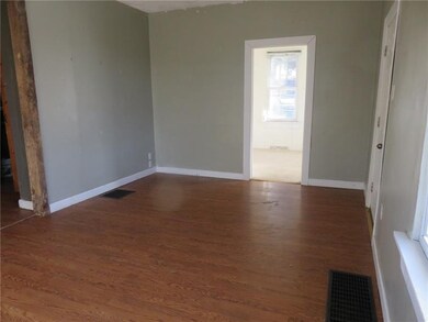 Living room with front door to the right and the i