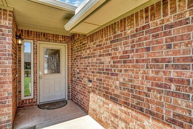 Property entrance featuring brick siding