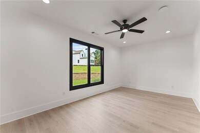 Empty room featuring ceiling fan, recessed lighting, and light wood finished floors