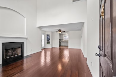 Unfurnished living room with a ceiling fan, a high