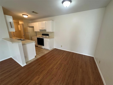Kitchen with white appliances, under cabinet rang