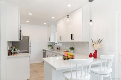 Modern kitchen with brand new cabinets, quartz counters and seamless backsplash