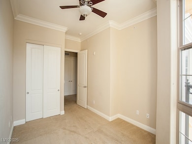 Unfurnished bedroom featuring light carpet, crown