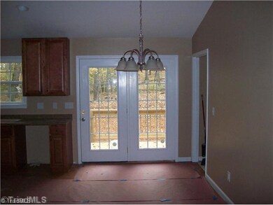Dining Room. Dining room adjacent to the kitchen features vaulted ceiling.