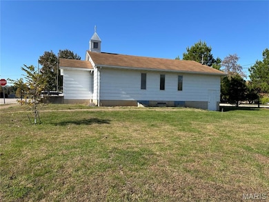 Rear view of house featuring a yard