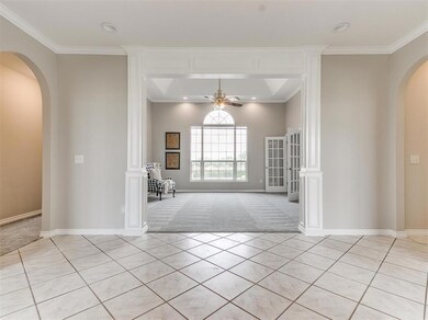Unfurnished living room with ornate columns, light